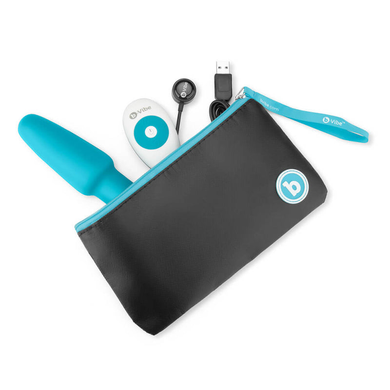 The b-Vibe Rimming Plug 2 inside the zippered pouch with the tip peaking out. The remote and charging cable are also peaking out next to it. The zippered pouch is pretty large for all of these items, and it would fit them all comfortably. | Kinkly Shop