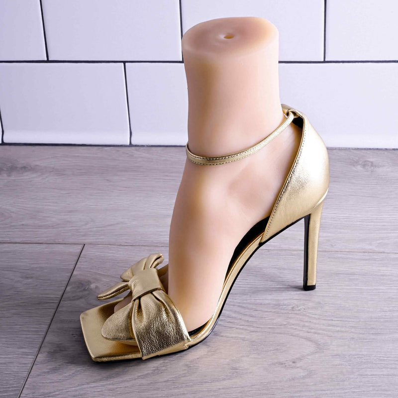 A different angle of the Evolved Pussy Footin' within a gold high-heeled shoe. | Kinkly Shop