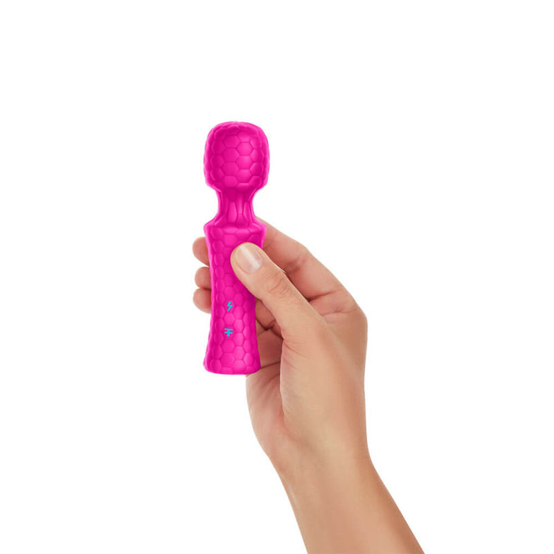 A hand holds the FemmeFunn Ultra Wand Mini in Pink against a white background. The wand massager looks surprisingly short in height, and it is barely longer than the person's hand. It looks adorably tiny. | Kinkly Shop