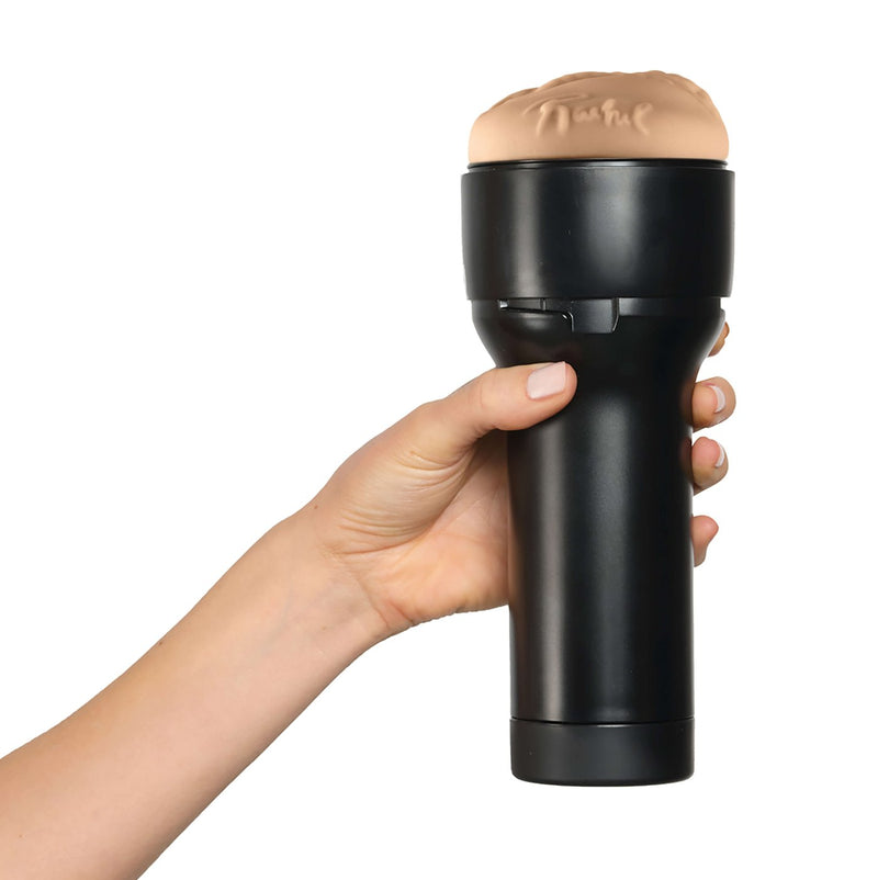 A hand holds the KIIROO FeelStars FeelRachel Stroker in front of a plain white background. Their hand seems to wrap comfortably around the plastic case. | Kinkly Shop
