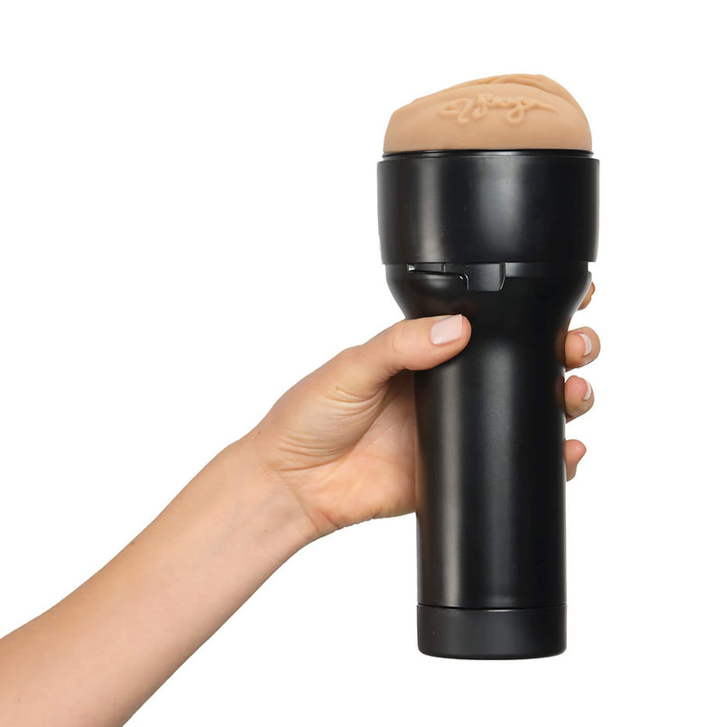 A hand holds the KIIROO FeelStars FeelReya Stroker. The stroker's handle looks like it fits comfortably into the person's hand. | Kinkly Shop
