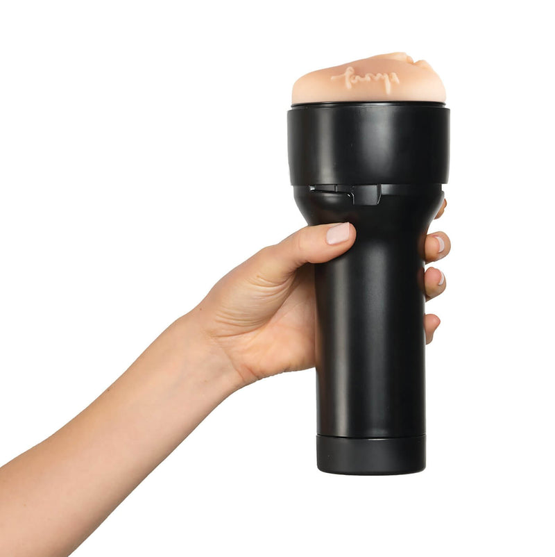 A hand is wrapped around the handle of the stroker. It looks like it's comfortable to grip the KIIROO FeelStars FeelTanya Stroker | Kinkly Shop