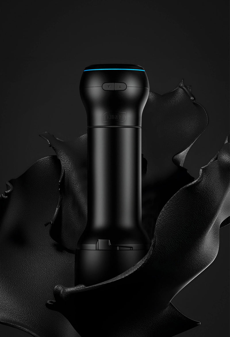 The KIIROO PowerBlow Attachment attached to a KIIROO stroker case shown up against a black background. The blue LED light at the top of the KIIROO PowerBlow Attachment makes the Power Blow look extremely futuristic. | Kinkly Shop