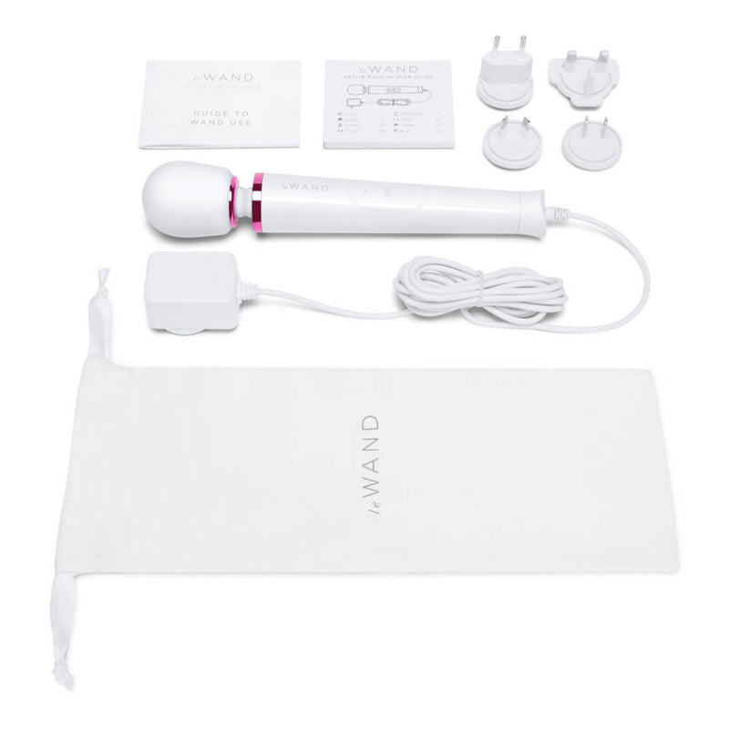 The Le Wand Petite Plug-In Massager in white with everything it comes with. There's the wand itself, the power cord, 4 international plug-in plates, a guide to using the wand, the technical manual, and a drawstring bag to store all of it. | Kinkly Shop