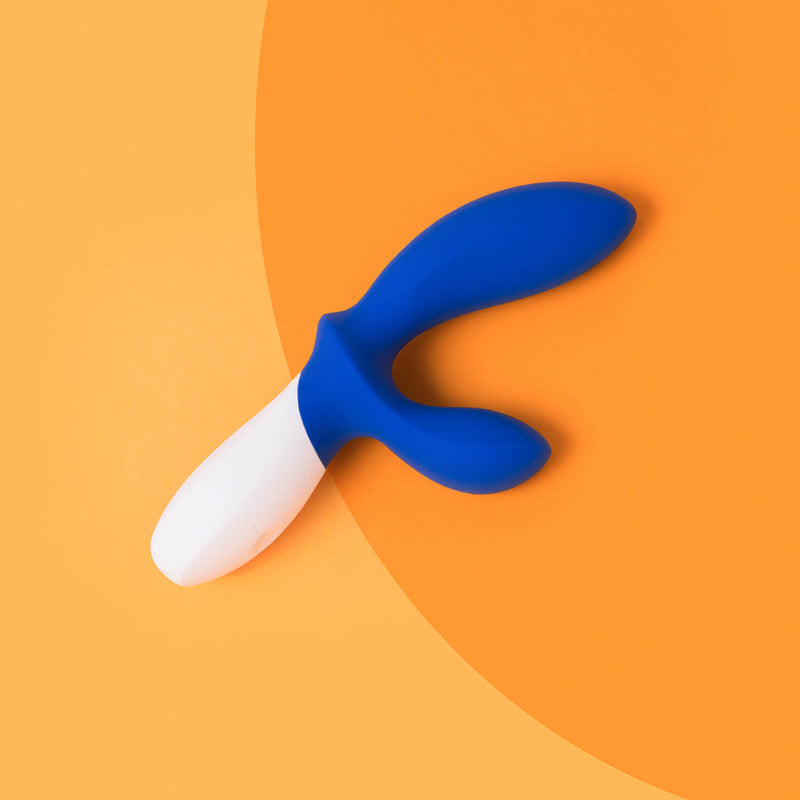The LELO LOKI Wave in Federal Blue up against a two-tone orange background. The blue color contrasts beautifully with the orange. | Kinkly Shop