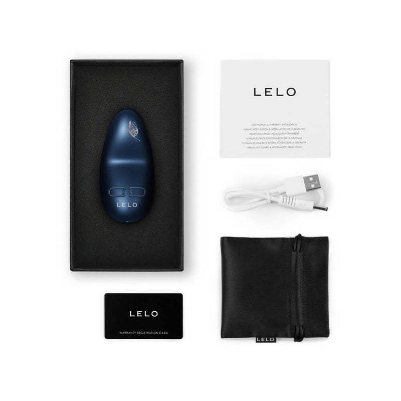 Everything that comes with the LELO NEA 3. There's the vibrator itself, the warranty card, the instructions, the charging cable, and a black drawstring storage bag. | Kinkly Shop