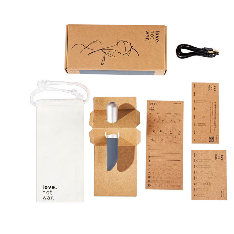 Everything that comes with the Love Not War Amore. The packaging is cardboard-focused with everything, including the instructions, in cardboard. The Love Not War Amore also comes with a cotton drawstring bag and a charging cable. | Kinkly Shop