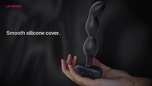 GIF shows a person holding the Lovense Ridge against a black background. The tip of the Lovense Ridge is rotating as the person holds it, and the person's hand is staying still. The Ridge's tip rotates in circles through automation. Text on the GIF reads: "Smooth silicone cover. Flared base. Easy to remove." | Kinkly Shop