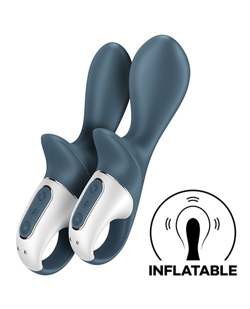 Two of the Satisfyer Air Pump Booty 2 toys sitting next to one another. The toy on the left is fully deflated, looking slimmer in thickness. The toy on the right is fully inflated, looking much thicker than the full deflated version. An illustrated icon in the lower right corner says "Inflatable" and shows the thickening design of the tip. | Kinkly Shop