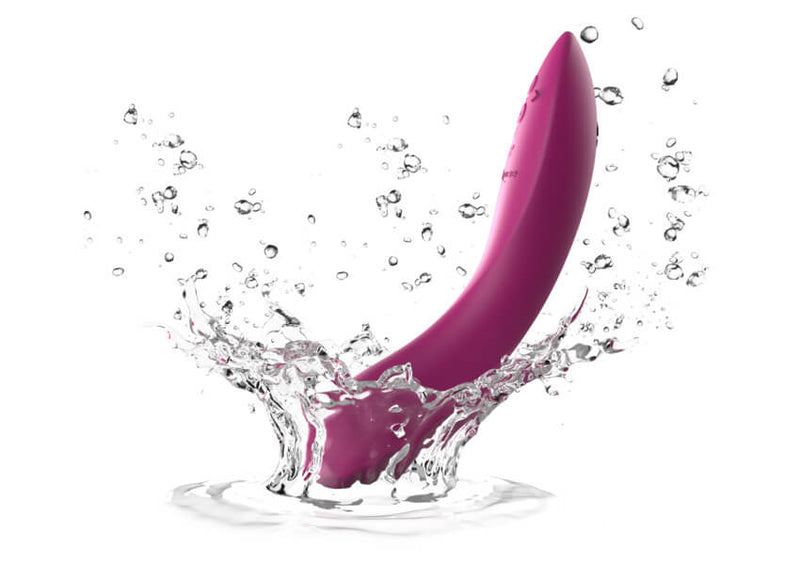 An illustration of the We-Vibe Rave 2 being dropped into a puddle of water to showcase the vibrator's waterproof capabilities. | Kinkly Shop