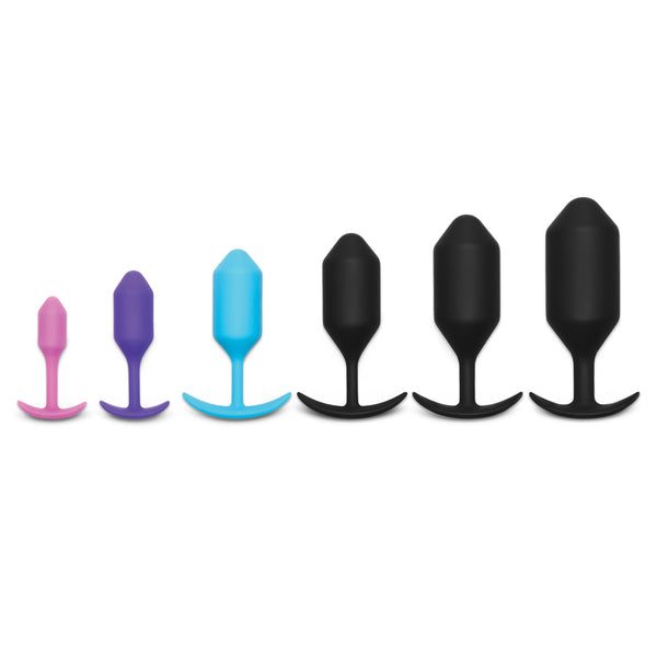 The entire b-Vibe Snug Plugs line-up, one next to another, lined up left to right from small to large. | Kinkly Shop
