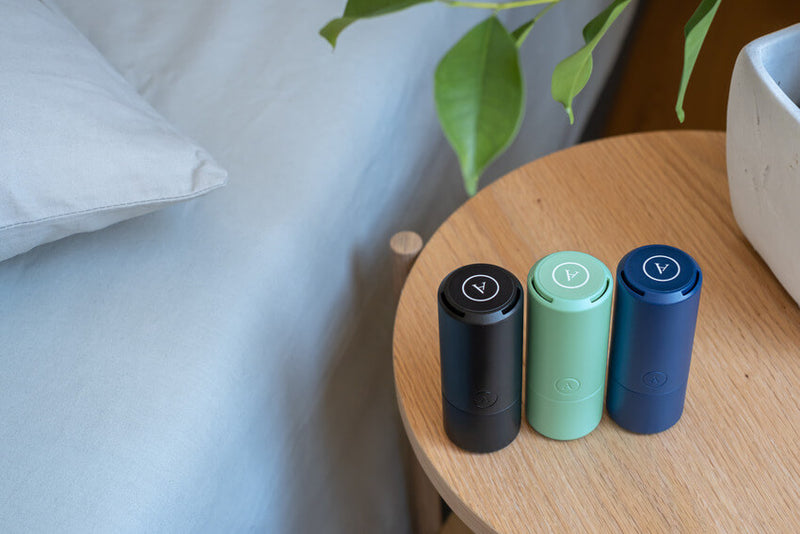 All three colors of the Arcwave Ghost sitting out on a bedside table. They look very small and portable. | Kinkly Shop