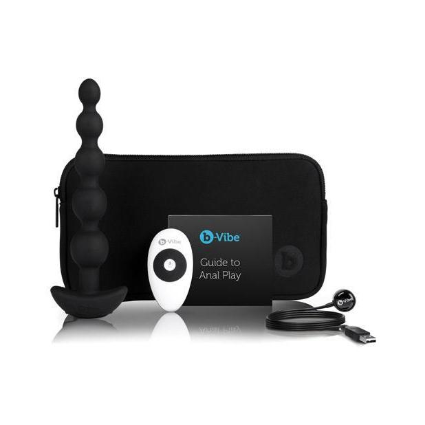 b-Vibe Cinco Remote Control Rechargeable Beads sitting out next to everything that comes with it including the storage bag, the vibrating anal beads remote control, the anal play guide, and the charging cable. | Kinkly Shop