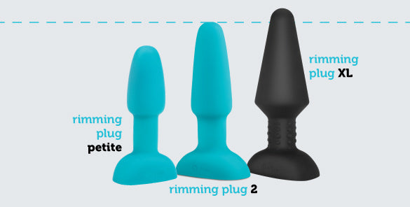 The b-Vibe Rimming Plug 2 shown next to two other plugs in the b-Vibe line to showcase the difference in sizes. The Rimming Plug Petite is shorter and skinnier than the Rimming Plug 2. The Rimming Plug XL is noticeably taller and thicker than the Rimming Plug 2. | Kinkly Shop