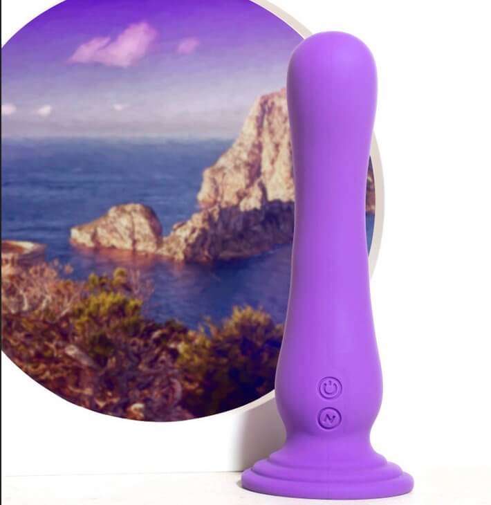 Blush Impressions Ibiza dildo shown in front of an image of a sea. | Kinkly Shop