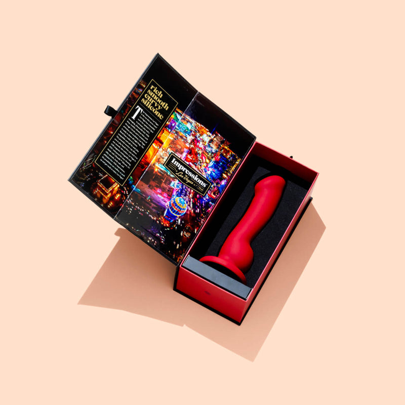 The Blush Impressions Las Vegas rests in the foam insert inside of its packaging. The box is open and displaying the sex toy laying there. | Kinkly Shop