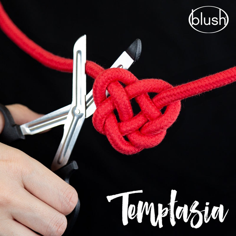A person holding the Blush Safety Shears is about to cut into a knot tied with the Temptasia Red Cotton Rope. | Kinkly Shop