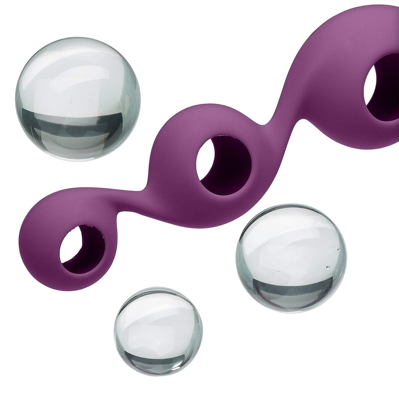 Image shows the glass Kegel balls popped out of the 3-ball silicone sleeve. You can see that the silicone sleeve of the Cloud 9 Borosilicate Kegel Training Set is hollow. | Kinkly Shop