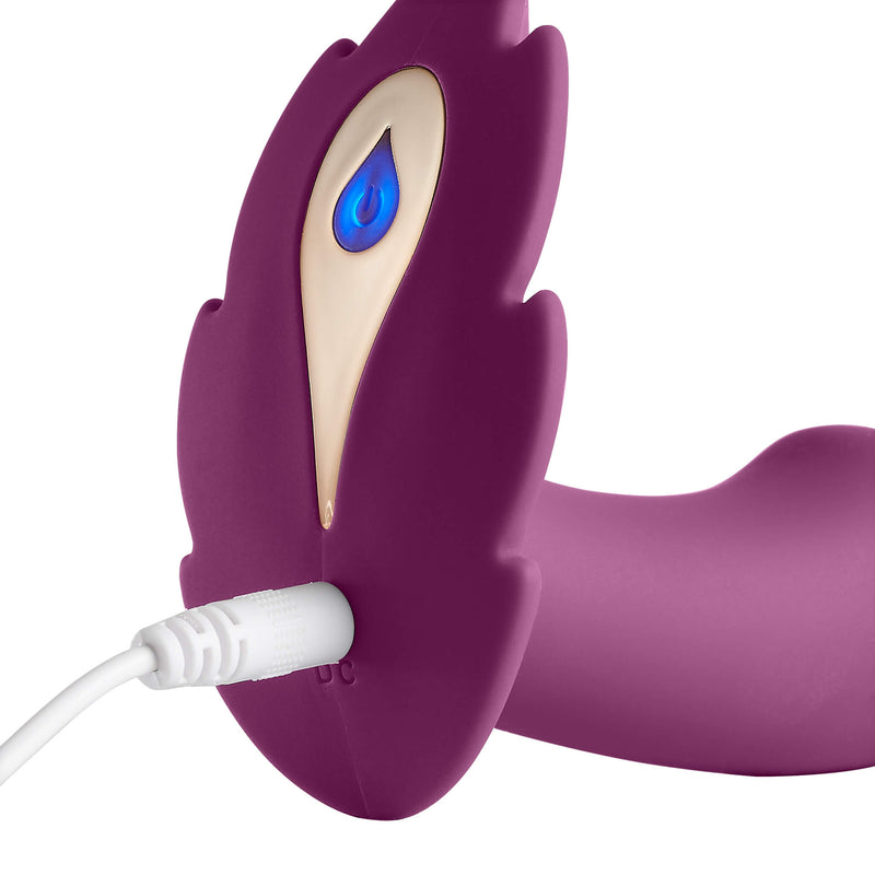 A close-up shot of the Cloud 9 Wireless Remote Control Panty Leaf Vibe shows the vibrator plugged in. The power button is light up in a purple-ish hue to show that it's charging. | Kinkly Shop