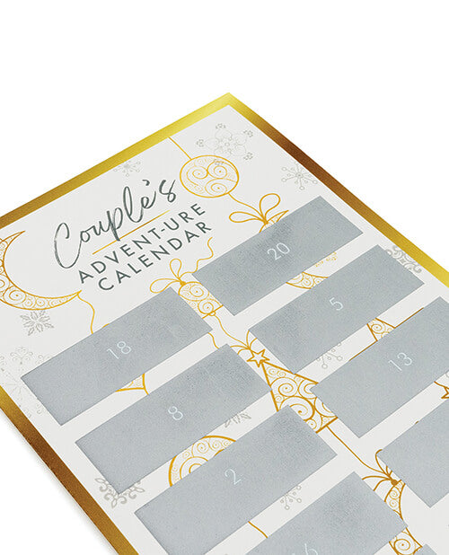 A close up of the Couple's Advent-ure Calendar. This showcases the white and gold coloration of the calendar as well as the fact that each one of the silver, scratch-off squares is numbered. | Kinkly Shop