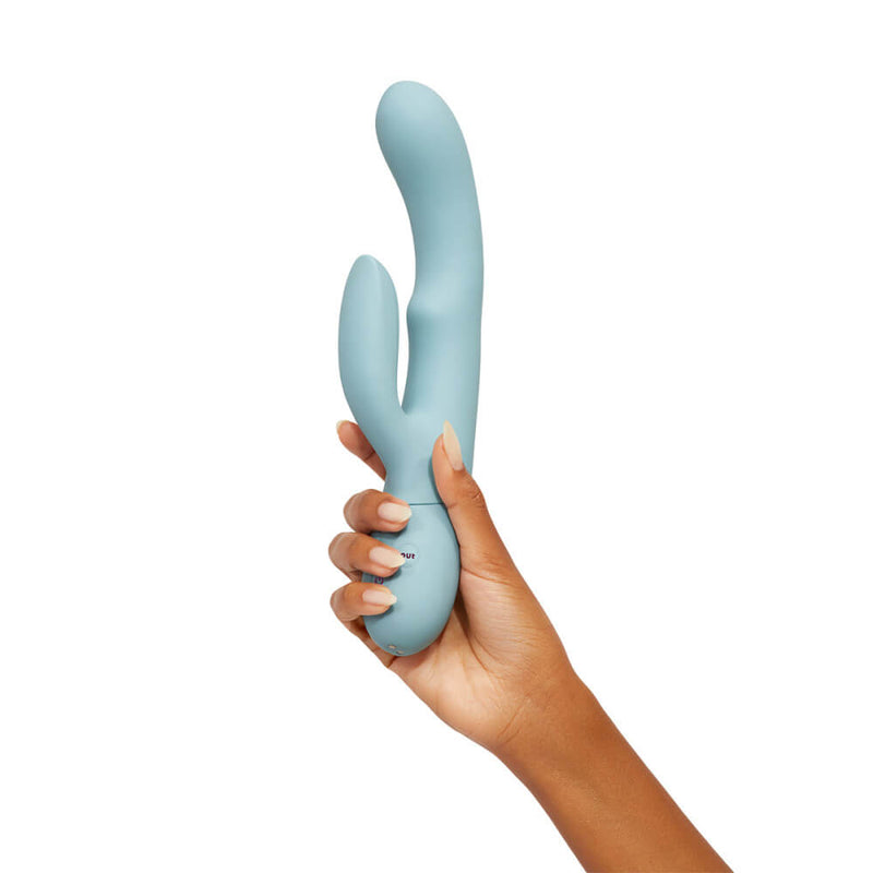 A hand holds the FemmeFunn Balai. The rabbit vibrator is much longer than the hand and would be much longer than the tip of the fingers to the base of the palm. The insertable shaft appears to be about as thick as three fingers. | Kinkly Shop