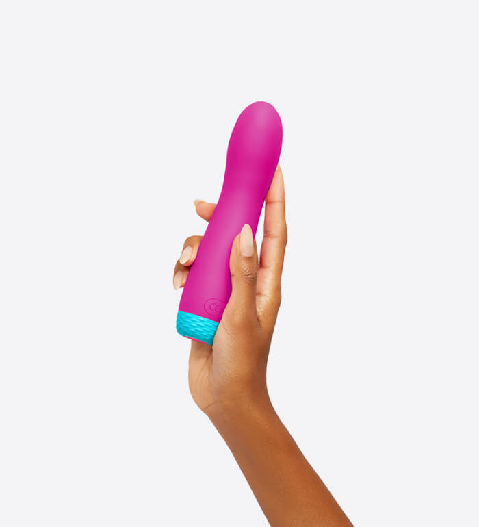 A hand holds the FemmeFunn Rora Rotating Bullet in Pink. The vibrator is slightly longer than the person's palm. It's about 2.5 fingers in thickness. | Kinkly Shop