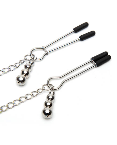 Close-up of the nipple clamps. One clamp is fully open while the other clamp of the "Play Nice" Satin Collar with Nipple Clamps is fully closed. Each clamp also has a small, four-ball charm that drapes off of it. | Kinkly Shop