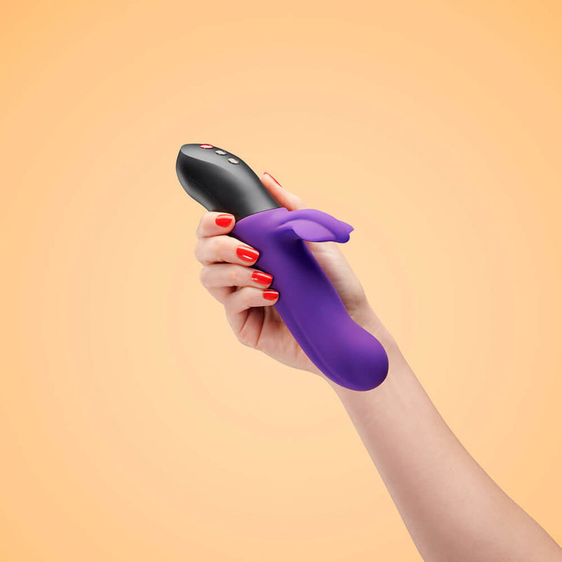 A hand holds the Fun Factory Bi Stronic Fusion with the vibrator pointing back towards the hand holder. The vibrator is much longer than their hand. | Kinkly Shop