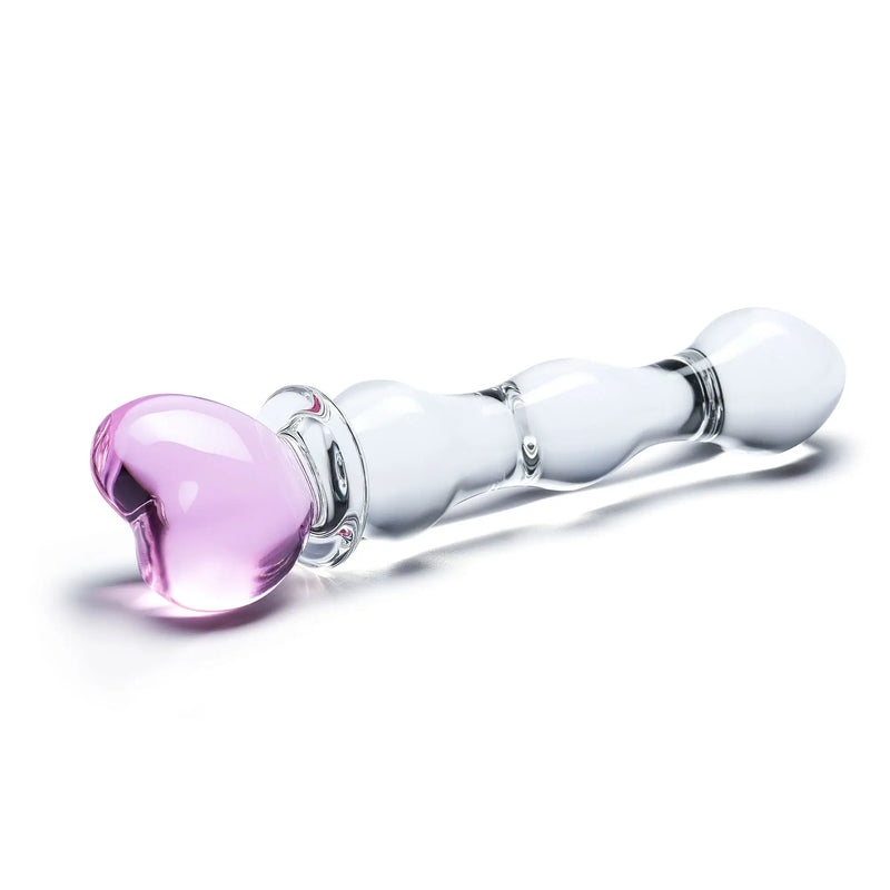 A close-up of the heart tip on the end of the 8" Sweetheart Glass Dildo. The heart is clearly a pink-tinted glass while the shaft is clear glass. | Kinkly Shop