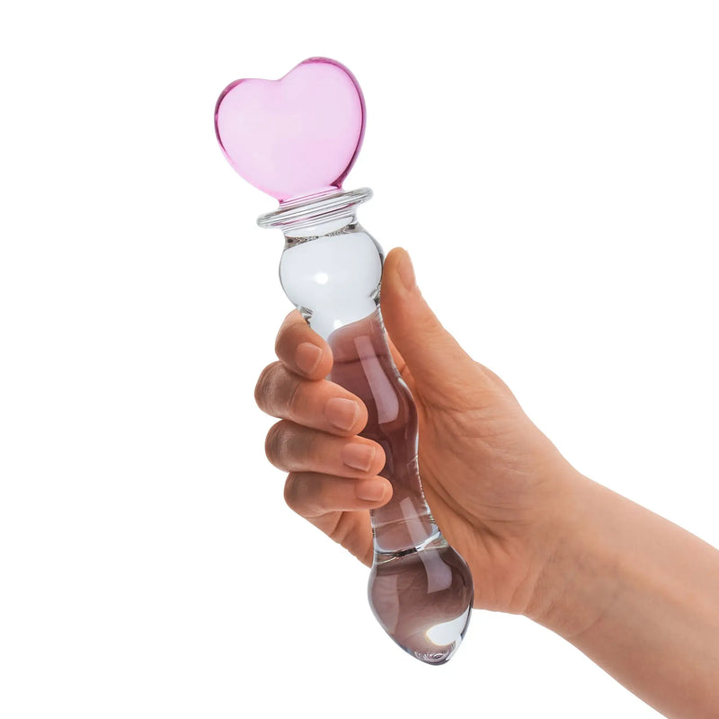 A hand holds the 8" Sweetheart Glass Dildo. The hand takes up 2/3 of the insertable length of the dildo while gripping it. | Kinkly Shop