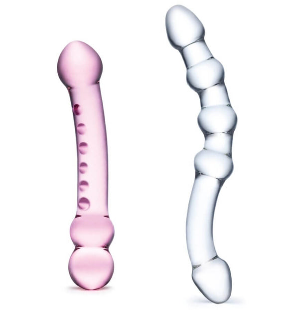 Both dildos included in the GLAS Double Pleasure Set sitting out in front of a white background. The pink dildo is slightly thicker and shorter than the clear dildo. Both are double-ended. | Kinkly Shop
