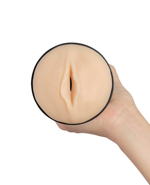 A close-up view of the vaginal orifice of the KIIROO RealFeel Original penis stroker. The stroker is a beige color. | Kinkly Shop