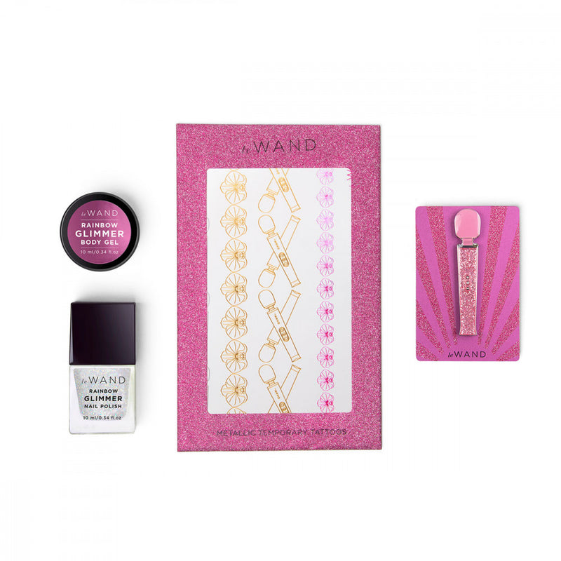 The matching accessories that come with the Le Wand All That Glimmers Wand Massager in a close-up image. It shows the container of matching body gel, the glittery nail polish, the matching temporary tattoos, and the enemal pin that's a mini copy of the petite wand itself. | Kinkly Shop