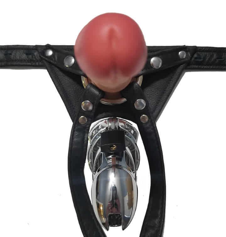 Close-up of the Locked in Lust Crotch Rocket Penis Chastity Strap On Harness shows how it fits around a chastity cage. We have a top-down view of a dildo strapped into the harness while the chastity cage sits beneath the harness with no issue because the harness straps go around it. | Kinkly Shop