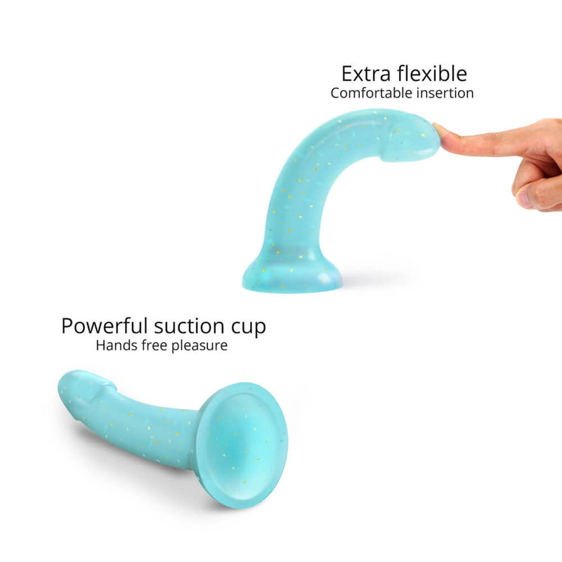 Two images compiled into one. In one, a person's finger is bending the DilDolls Love to Love dildo to a 90-degree angle while the dildo is adhered to a flat surface. The text reads "Extra flexible, comfortable insertion". In the other image, the dildo is laying flat on a surface with the suction cup base pointed at the camera. The text reads "Powerful suction cup, Hands-free pleasure". | Kinkly Shop