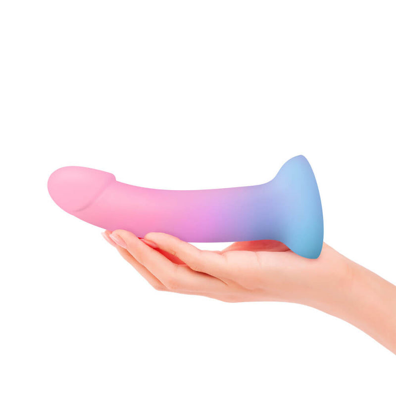 A hand holds out the Love to Love DilDolls. The dildo is longer than the person's hand and extends past their fingers. The dildo is about the thickness of three of their fingers in a diamond-like shape. | Kinkly Shop