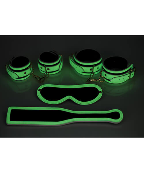 This glow-in-the-dark image shows the same set-up as the previous photo - only now all of the lights are off. All of the parts of the Master Series Kink in the Dark Set that were white now glow with a green hue in the dark. | Kinkly Shop