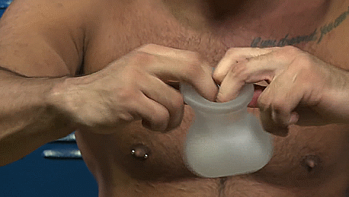 GIF of a shirtless person gripping the entrance of the Perfect Fit Bull Bag. They pull to showcase how the Bull Bag has some stretchiness to make it easier to insert the balls. | Kinkly Shop