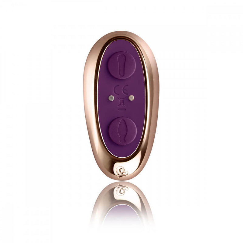 Close-up of the Rocks-Off Cocktail remote. This showcases the two separate buttons on the remote. Each button controls one of the two motors. In the middle of the buttons, there are two magnetic contact points that function as the charging point for this vibrator remote. | Kinkly Shop
