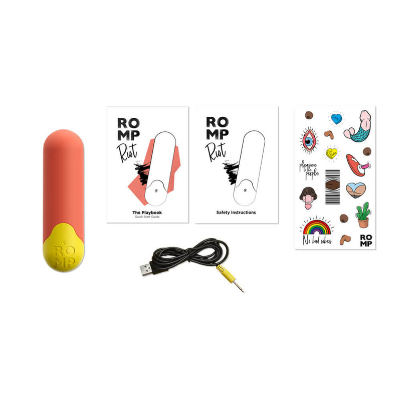 The ROMP Riot bullet vibrator laying out on a white background with everything the vibrator comes with. It has the vibrator, the charging cable, instruction manuals, and a sticker sheet. | Kinkly Shop