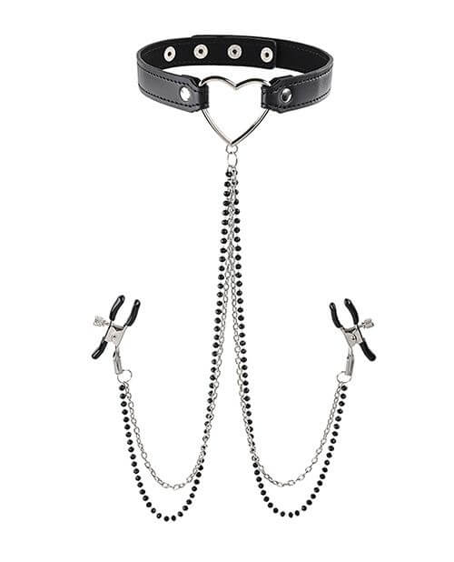 The Sportsheets Sex & Mischief Amor Collar with Nipple Clamps up against a white background. The collar displays the heart-shaped ring in the front with multiple button snaps to fasten it closed. Two alligator nipple clamps, both with two long chains, are directly connected to the bottom of the heart piece on the collar. | Kinkly Shop