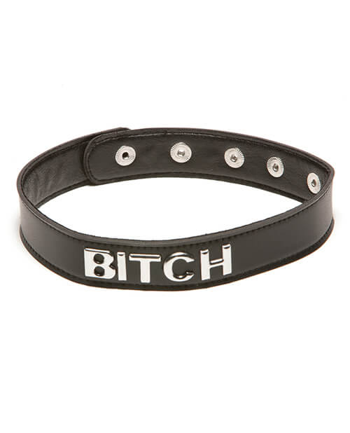Bitch Talk Dirty to Me Collar. It's a slend, black collar that has multiple snap closures on the backside of the collar. On the front, the collar's text has the word written out in silver capital letters. | Kinkly Shop