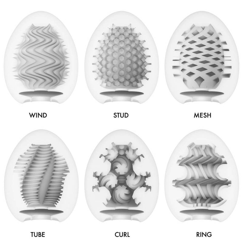 Tenga Egg Wonder variety pack. Six colorful, bright Tenga Eggs are laid out on top of a white background. The colorful patterns on the packaging match the texture found within each stroker. The kit includes Wind, Stud, Mesh, Tube, Curl, and Ring. | Kinkly Shop