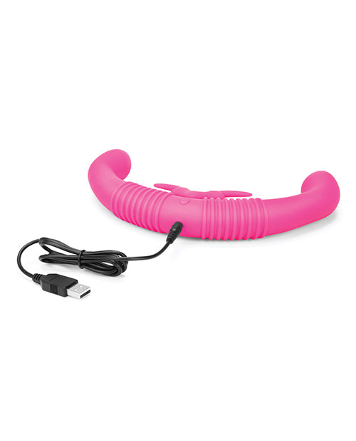 This image shows the vibrator charger plugged into the Together Toy Shared Vibrator for Couples to charge it. The charger cable is a USB cable, and the charging port is located on the bottom of the vibrator opposite the clitoral arms. | Kinkly Shop