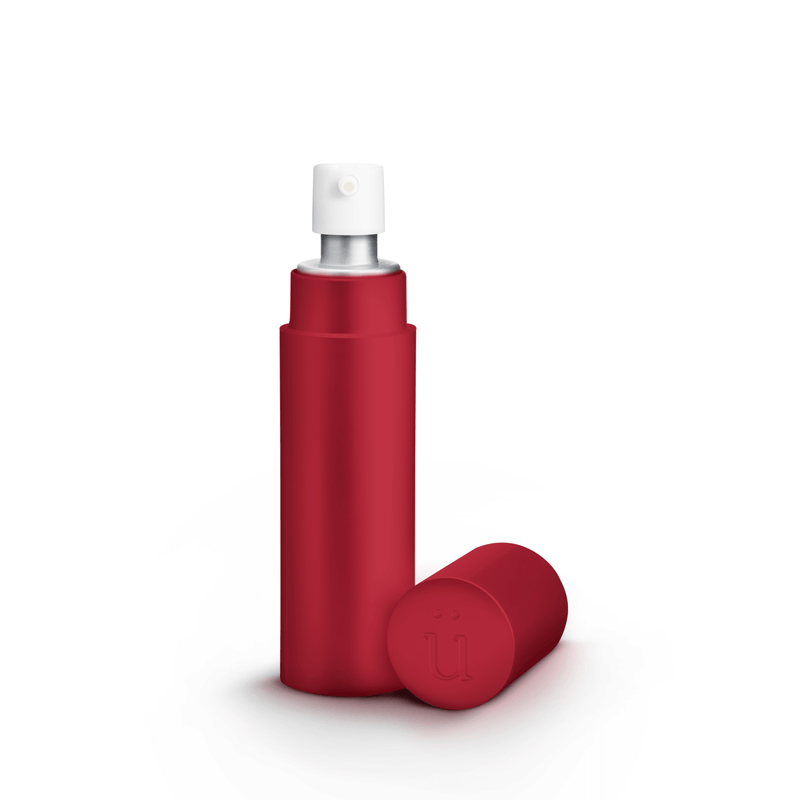 Überlube Good-to-Go Travel Size Lube in Red. The image shows the opaque design of the outer case with the pump-top of the lube bottle sticking out from inside the case. The lid (with an embedded "U" on top) is sitting next to the case. | Kinkly Shop