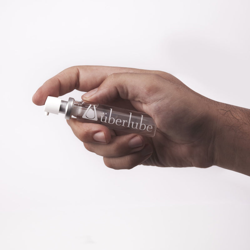 Person holding a travel-size, 15ml uberlube bottle in their hand | Kinkly Shop
