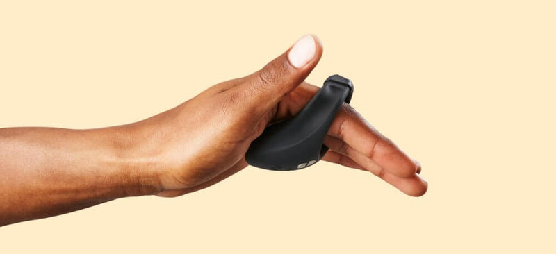The We-Vibe Bond is slid onto a hand's pointer finger and middle finger. This image shows how the We-Vibe Bond vibrating penis ring wraps underneath the "hand" and into the palm. This part that slides underneath the body is gently triangular in shape with a thick motor for the most pleasure and comfort possible. | Kinkly Shop