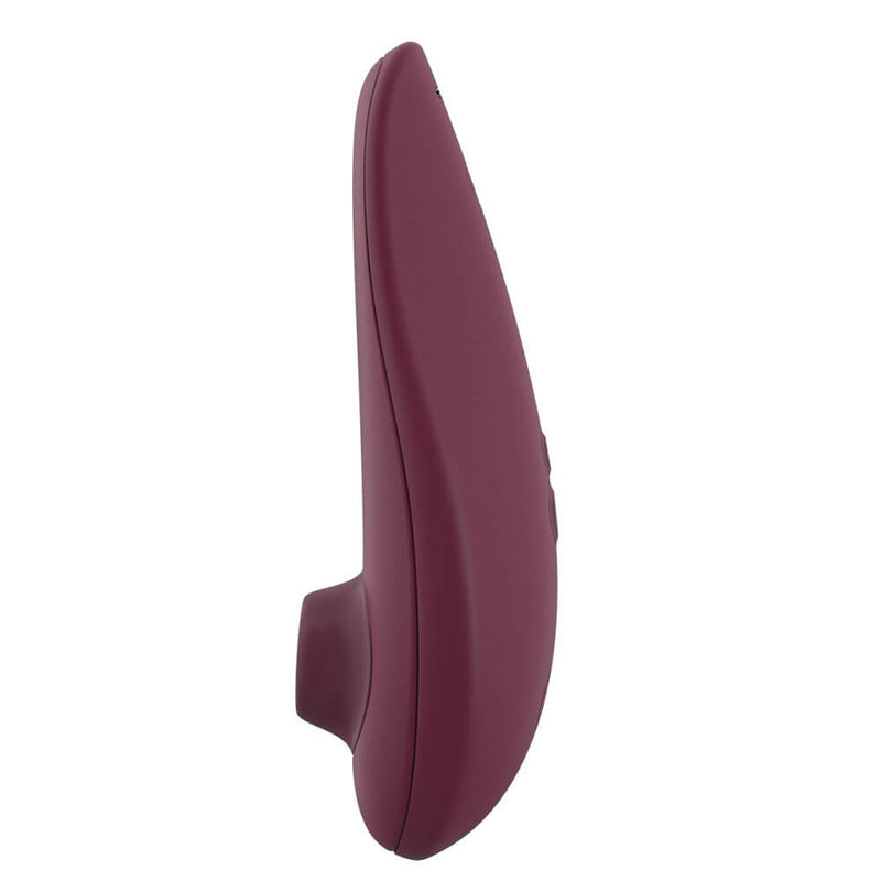 A view of the Womanizer Classic 2 from its side. The side with the air suction tip on it is virtually straight with no curves. The opposing side, with all of the buttons on it, however, is extremely curved. | Kinkly Shop