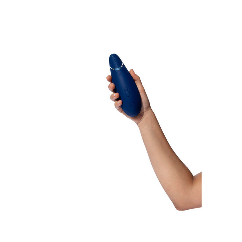 A person holds the Womanizer Premium 2 in their hand. This shows that the Womanizer Premium 2 is much, much longer than a spread-out hand, and its width fills up the majority of the palm. | Kinkly Shop