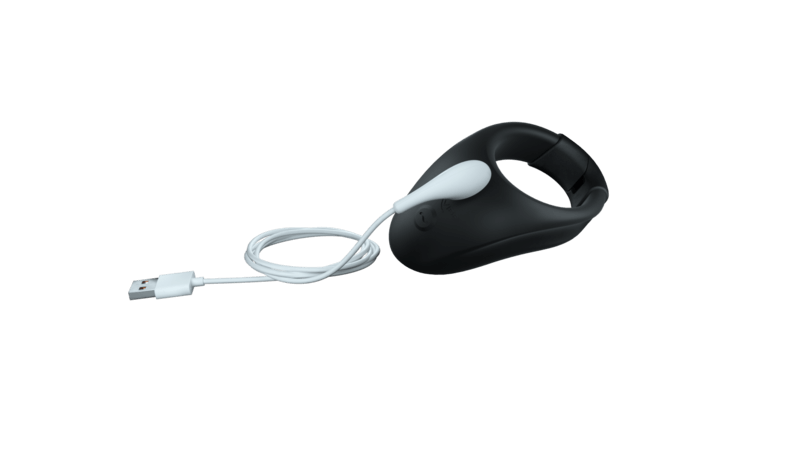 The We-Vibe Bond with the charging cable hanging off the charging port to show how the We-Vibe Bond charges. It's a magnetic design that "snaps in" to the proper spot for charging. | Kinkly Shop